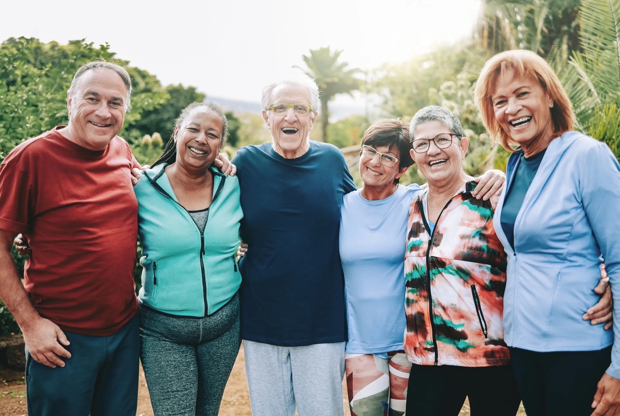 Community members smiling and supporting each other outdoors